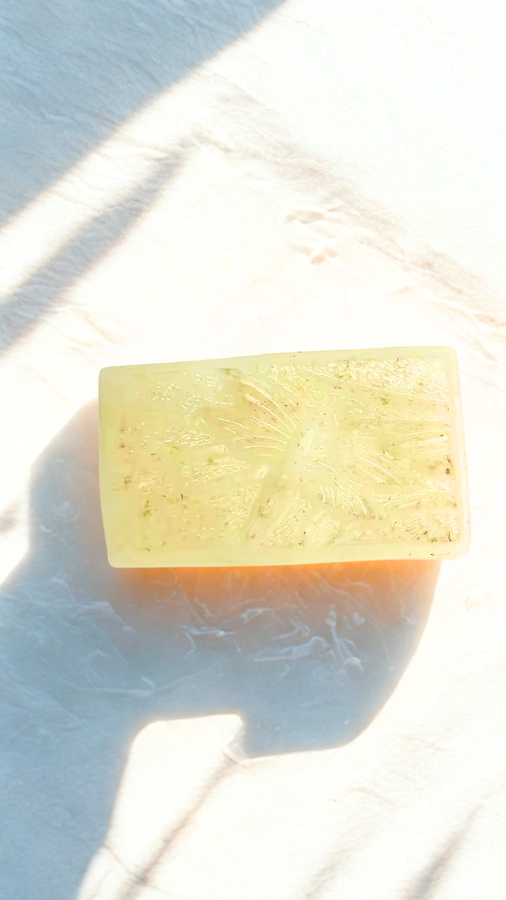 Bar Moonflower soap on a white surface with a light blue gradient background