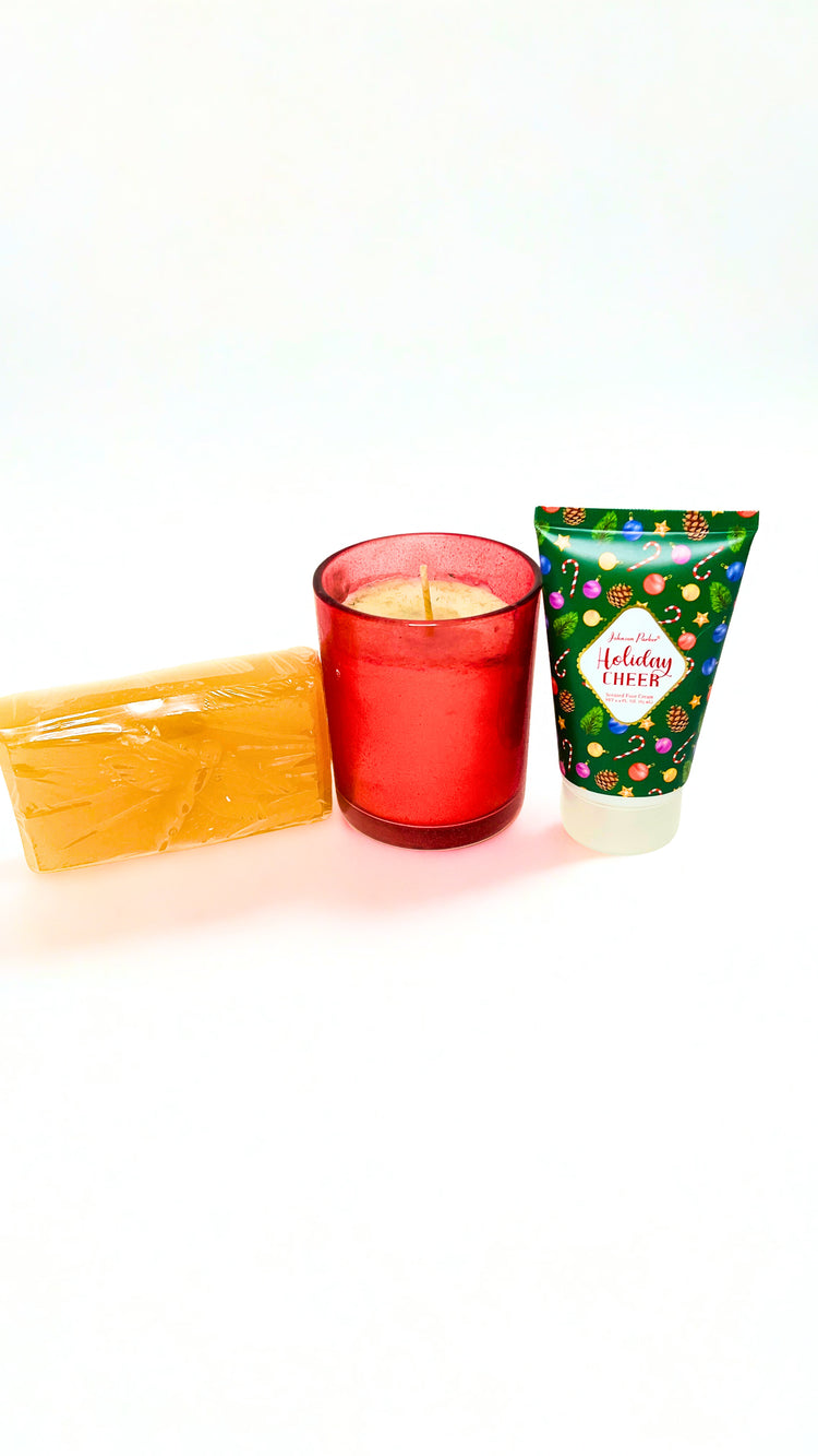 Red candle, soap, and floral-patterned foot cream bottle on a white background