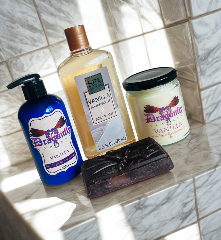 Vanilla soap lotion candle body wash and shower puff on a tiled surface.
