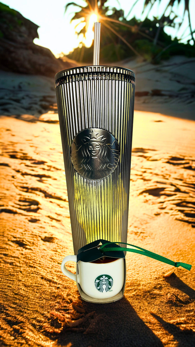 Starbucks cup with lid on a beach at sunset with ornament