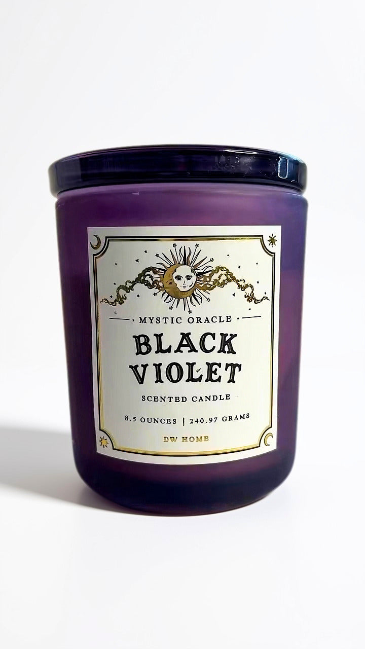 A purple glass jar candle with a black lid and a cream label reading 'Mystic Oracle Black Violet Scented Candle' on a white background.