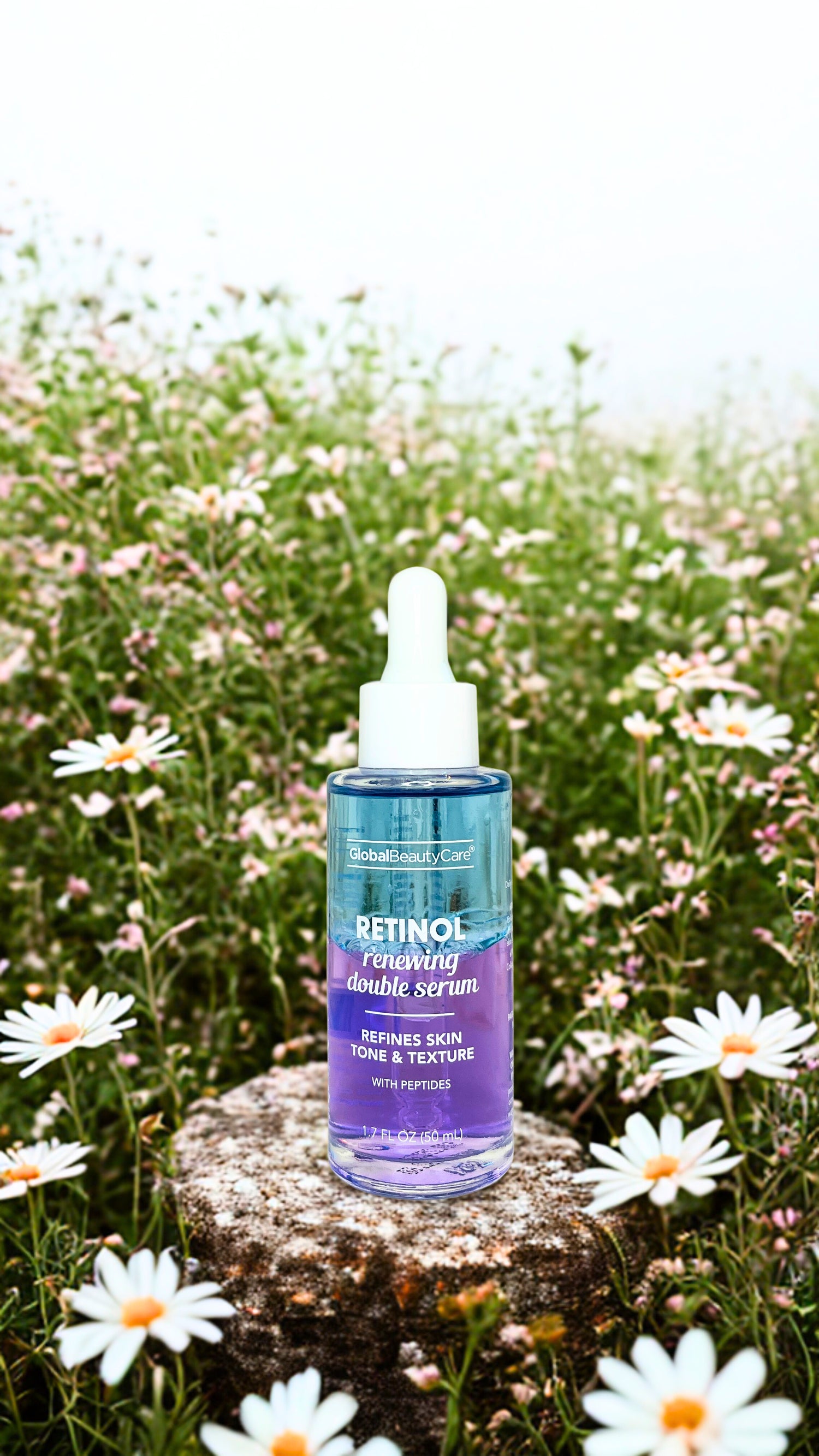Limited Edition Retinol serum bottle on a rock with flowers in the background