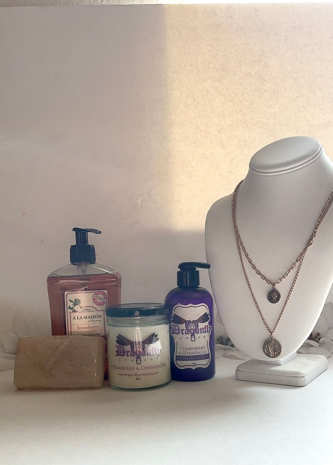 Strawberry and Champagne  products including a necklace  a white surface.
