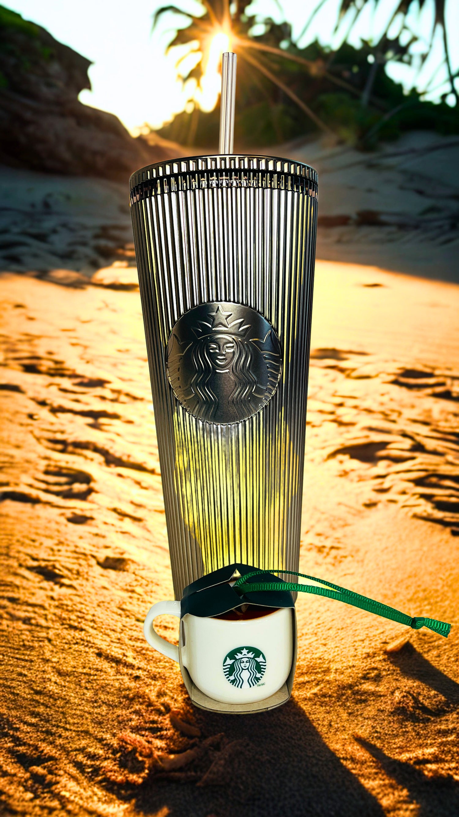 Starbucks cup with lid on a beach at sunset with ornament 